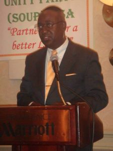 A person in a suit and tie Description automatically generated with low confidence