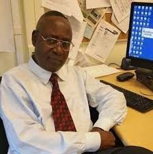 A person sitting at a desk with his arms crossed AI-generated content may be incorrect.